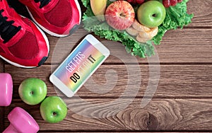 Fitness healthy lifestyle mockup smartphone concept. Get Fits Don`t Quit quote on mobile phone with sport shoes, dumbbells and photo