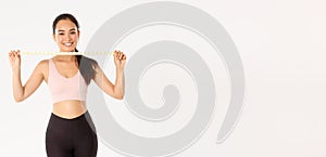 Fitness, healthy lifestyle and wellbeing concept. Portrait of smiling asian brunette sports girl, female athelte in
