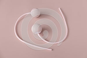 Fitness and healthy sport concept. Pink ropeless jump rope on a pastel pink background