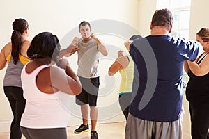 Fitness Instructor In Exercise Class For Overweight People