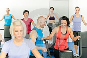 Fitness instructor leading class of alpinning