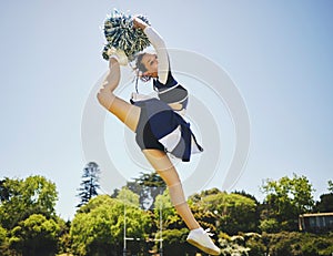 Fitness, jump and woman cheerleader on a field for motivation or support practice with team. Sports, cheerleading and