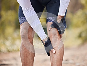 Fitness, knee pain and man hands in forest with cycling, sports or injury, muscle or joint accident outdoor. Leg