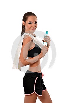 Fitness lady with towel over her shoulder and a bottle of water