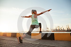 Fitness and lifestyle concept - woman doing sports outdoors