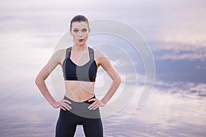 fitness and lifestyle concept - woman doing sports outdoors on a beach