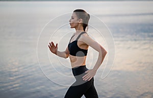 fitness and lifestyle concept - woman doing sports outdoors on a beach