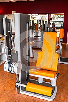 Fitness machine for strength training for legs in weight room, bodybuilding concept