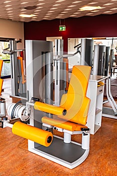 Fitness machine for strength training for legs in weight room, bodybuilding concept