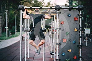 Fitness man doing pull ups and exercises