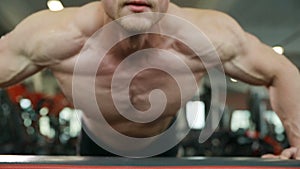 Fitness man doing push ups in gym