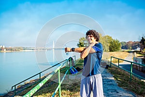 Fitness man doing stretching exercise, preparing for workout