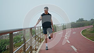 Fitness man doing stretching legs before running. Professional runner training