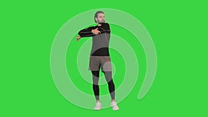 Fitness man doing warm up exercises on a Green Screen, Chroma Key.