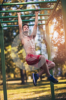 Fitness man doing workouts outdoors