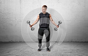 Fitness man lifting a dumbbell by both hands.