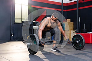 Fitness man lifting weights in gym fitness, Muscular man working out in gym doing exercises with barbell weight