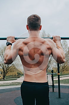 Fitness man with perfect body doing abdominal exercises in the Gym