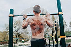 Fitness man with perfect body doing abdominal exercises in the Gym