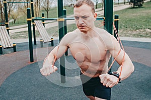 Fitness man with perfect body doing abdominal exercises in the Gym