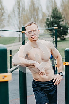 Fitness man with perfect body doing abdominal exercises in the Gym