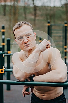 Fitness man with perfect body doing abdominal exercises in the Gym