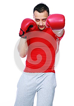 Fitness man punching with red boxing gloves