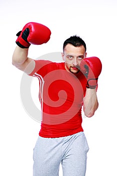 Fitness man punching with red boxing gloves