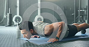 Fitness, man and pushups for muscle, exercise or training workout for strength or power at the gym. Athletic male in