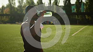 Fitness man sportsman drinking water from sport bottle in city refreshment hydration body healthy workout exercise break