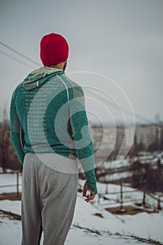 Fitness man standing outdoors looking at the cityscape