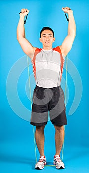 Fitness man use tubing to strengthen