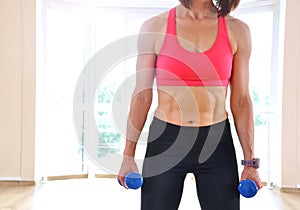 Fitness mature woman working out with dumbbells