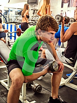 Fitness men friends in gym workout weights with equipment.