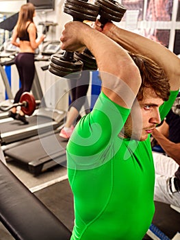 Fitness men friends in gym workout weights with equipment.