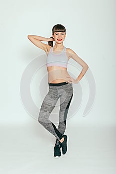 Fitness model in gray sportswear. Healthy lifestyle
