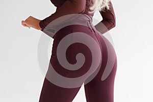 Fitness model in leggings with beautiful buttocks. Sporty booty