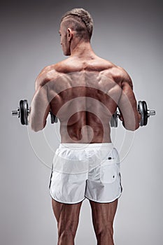 Fitness Model posing back muscles, triceps, latissimus