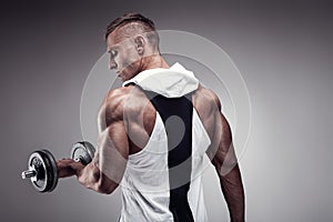 Fitness Model posing back muscles, triceps, latissimus