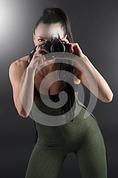 Fitness model taking using a camera to take a photo