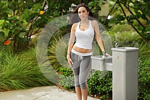 Fitness model by a water fountain