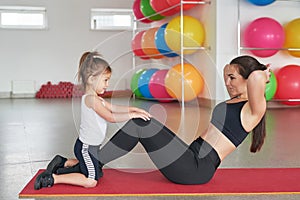 Fitness mother and child. Sports activities with children. Fitness center. Mom and baby gymnastics, yoga exercises. Health and