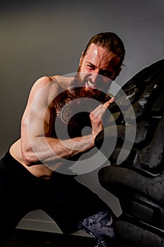 Fitness muscular gym tire wheel flipping male man ABS exercise, concept training weight from fit from huge concentration