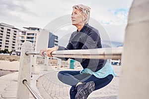 Fitness, music and stretching with a senior woman getting redy for a cardio workout on the promenade. Exercise, warm up