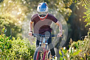 Fitness, nature and man cycling in training for a race competition on biking trail or woods. Action, sports or fast