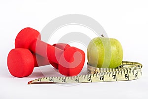 Fitness and Nutrition Fusion: Red Dumbbell, Measuring Tape, and Green Apple