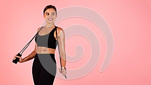 Fitness Offer. Beautiful Sporty Female Posing With Skipping Rope Over Pink Background