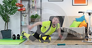 Fitness parody. Humor in sports. Expressive fitness guy doing training at home . Sports and comedians concept