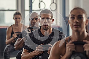 Fitness people exercising using kettle bell