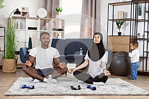 Fitness, people and healthy lifestyle concept - happy smiling african man and muslim arabic woman